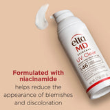 Elta MD UV Clear sunscreen bottle on a beige background with text about niacinamide benefits.