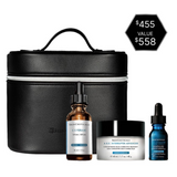 The Skinceuticals Holiday The Age Rewind Set displayed with its skincare product contents (C E Ferulic, A.G.E. Interrupter Advanced, and A.G.E. Interrupter Ultra Serum) in a black travel case with a price tag on a white background