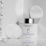 ZO Skin Health Complexion Renewal Pads jar with water droplets and two textured exfoliating pads in the background, highlighting salicylic acid formula for oily and acne-prone skin