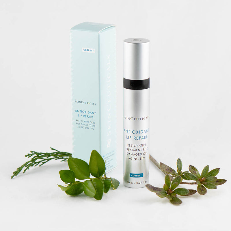 SkinCeuticals Antioxidant Lip Repair displayed with green plants highlighting nourishing, natural ingredients
