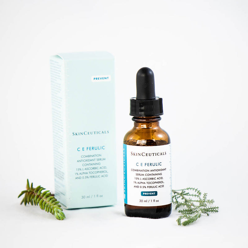 SkinCeuticals C E Ferulic serum bottle displayed with fresh flowers, highlighting its antioxidant-rich, rejuvenating formula