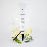 SkinCeuticals Retinol 0.5% tube styled with soft flowers – emphasizing its balanced strength for improving skin tone, texture, and visible signs of aging with a touch of elegance.