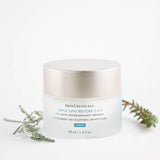 SkinCeuticals Triple Lipid Restore 2:4:2 cream displayed with green plants emphasizing nourishing, natural ingredients
