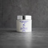 ZO Skin Health Acne Treatment Pads 60-count jar displayed on a grey concrete background, featuring 2% salicylic acid formula to treat acne, control oil, and minimize pores