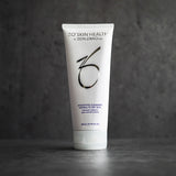 ZO Skin Health Hydrating Cleanser tube with silver and blue branding, standing upright against a dark gray textured background