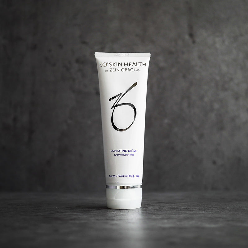 ZO Hydrating Creme jar placed on a modern, grey concrete background, showcasing clear product branding and packaging