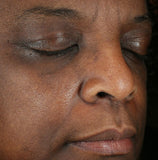 Close-up of a person's face with eyes closed