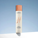 Hydrinity Hydri-C moisturizer bottle on a gradient blue background standing on a white ledge