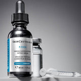 SkinCeuticals P-TIOX serum placed beside a syringe on a sterile surface, visually representing its role as a needle-free alternative or complement to injectable wrinkle treatments