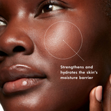 Dark-skinned woman applying SkinCeuticals Phyto Corrective Essence Mist, demonstrating lightweight, soothing hydration and redness reduction on diverse skin tones