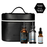 The Skinceuticals Holiday The Glass Skin Set displayed with its skincare product contents (Cell Cycle Catalyst, P-Tiox, and Phloretin CF) in a black travel case with a price tag on a white background
