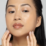 Vivier QuintiSerum being gently applied to the face, showcasing its lightweight formula with 15% Vitamin C, Vitamin E, and peptides, designed to enhance skin elasticity, smooth fine lines, and provide a radiant, youthful complexion