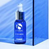 Blue serum bottle with dropper labeled 'IS Clinical Active Serum' on a blue background