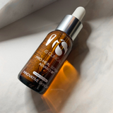 iS Clinical Pro-Health Serum Advance+ bottle placed upright on a smooth white marble surface