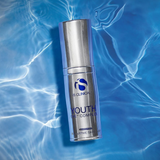 Skincare bottle labeled 'iS Clinical Youth Eye Complex' on a blue textured background