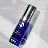 Bottle of the iS Clinical Copper Firming Mist slightly positioned slanted on a white and grey background