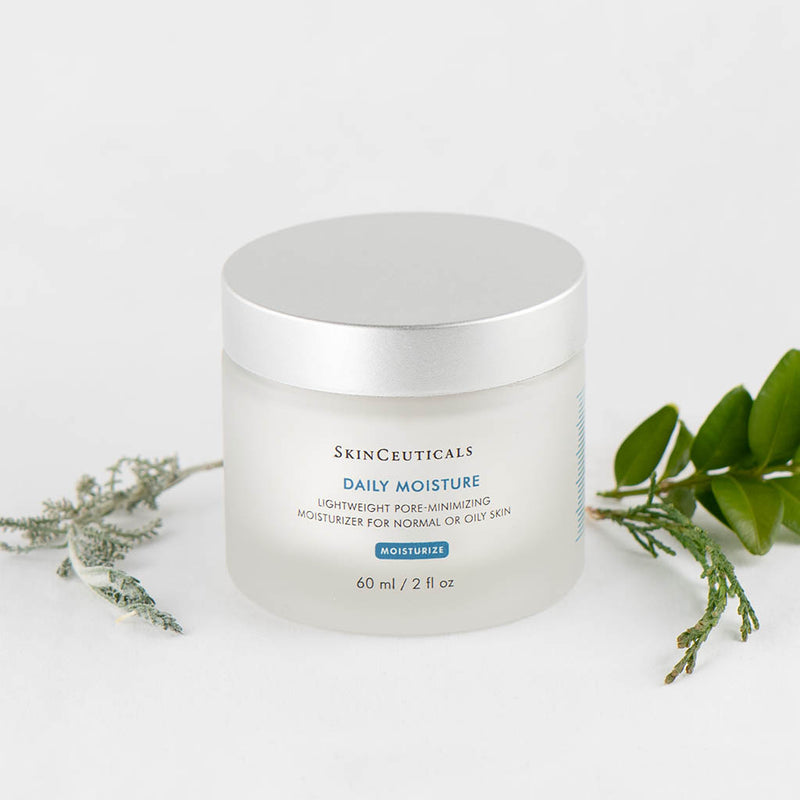 SkinCeuticals Daily Moisture facial moisturizer displayed with green plants highlighting botanical ingredients