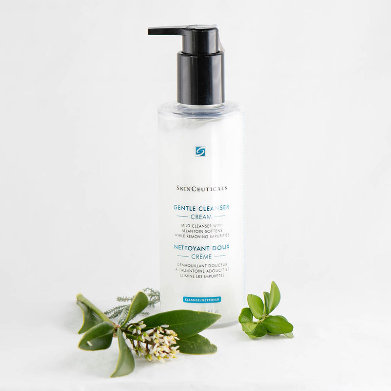 SkinCeuticals Gentle Cleanser bottle displayed among greenery and flowers, highlighting its soothing, sensitive-skin-friendly formula