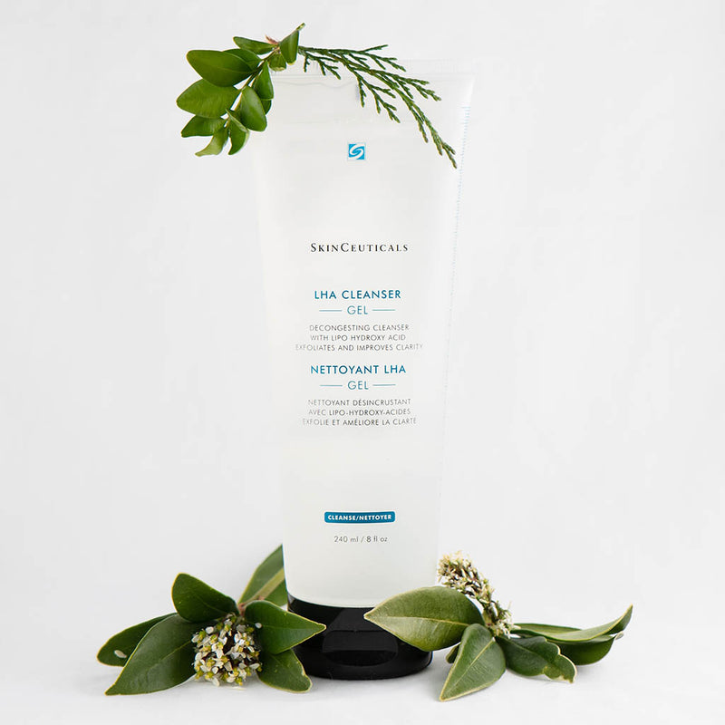 SkinCeuticals LHA Cleansing Gel bottle surrounded by fresh plants and flowers, emphasizing its natural-inspired, pore-purifying and brightening benefits