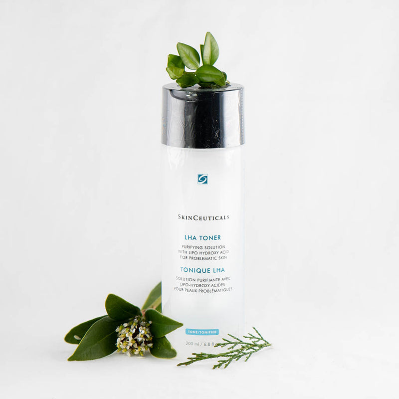 SkinCeuticals LHA Toner 200ml bottle surrounded by fresh flowers, highlighting its clarifying and gentle exfoliating properties for oily and aging skin
