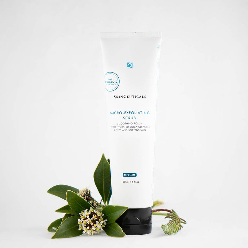 SkinCeuticals Micro-Exfoliating Scrub surrounded by fresh flowers, highlighting its gentle yet effective exfoliating formula