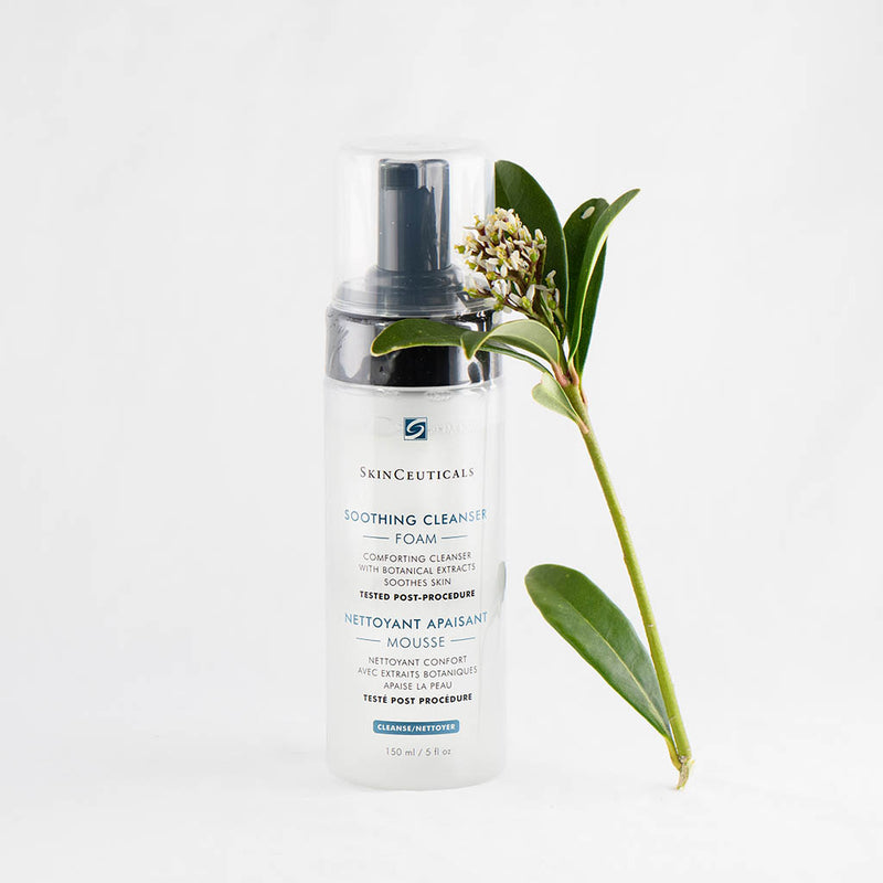 SkinCeuticals Soothing Cleanser bottle styled with fresh flowers, highlighting its calming, botanical-based formula for sensitive skin