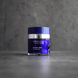 ZO Recovery Crème jar on a grey concrete background, showcasing its sleek, modern packaging