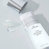 SkinMedica TNS Advanced+ Serum with cap off, showing texture and formulation with a smooth smear for luxurious anti-aging skincare.